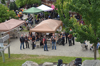 Some motorcycles, tents, and people.