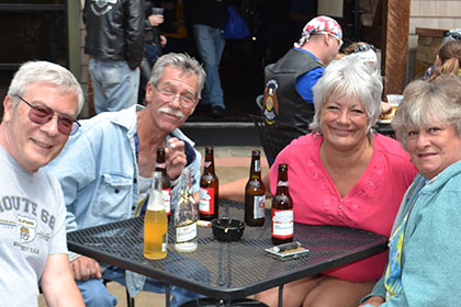 Group of people sitting at a table outside.