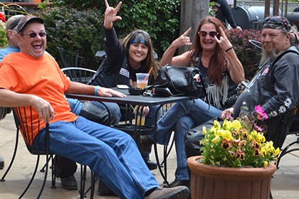 Happy people sitting at a table outside.