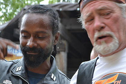 Two bearded men, one with a bandana.