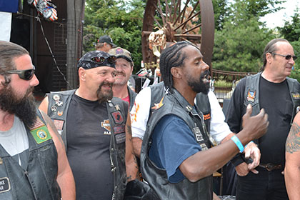 Seven guys in front of Ride for Life banner.