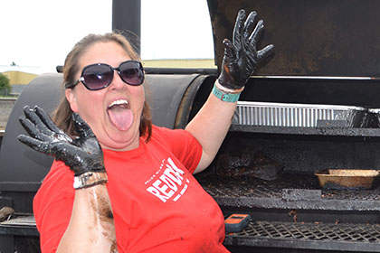 A man and woman showing their barbecuer