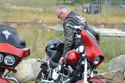 Man inspecting his motorcycle.
