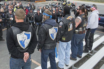 Group gathers around some riders.