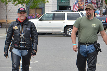 Two people walking in the parking lot.