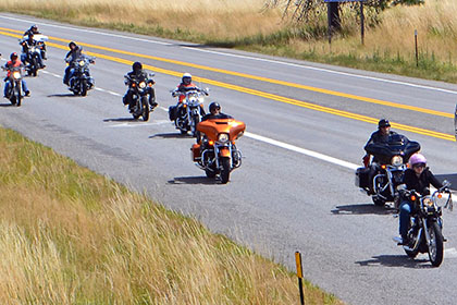 Line of motorcycles arriving at the event.