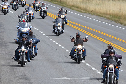 Motorcycles traveling on the road.