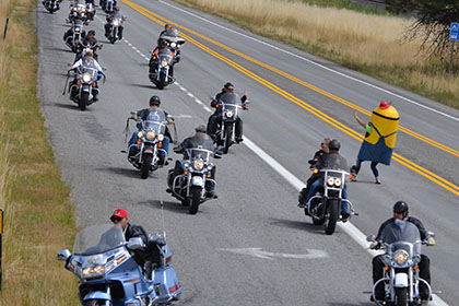 Long line of people riding their motorcycles to the event.