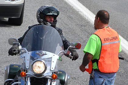 A man on his motorcycle speaks to a Ride for Life committee member.