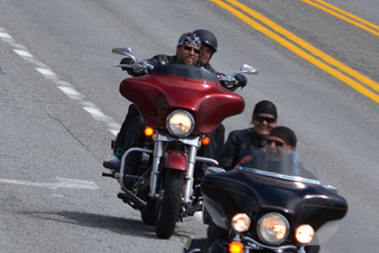 Group of four motorcylces on the road.