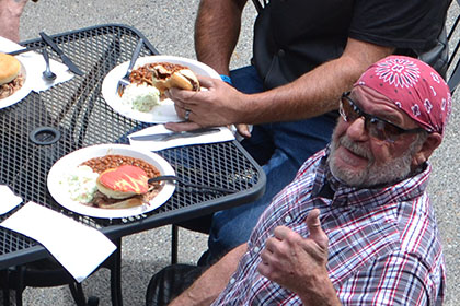 Four people enjoying their barbecue.