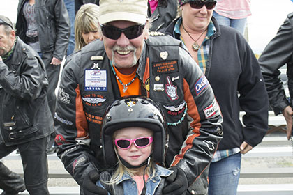 A man a child pose for a photograph.